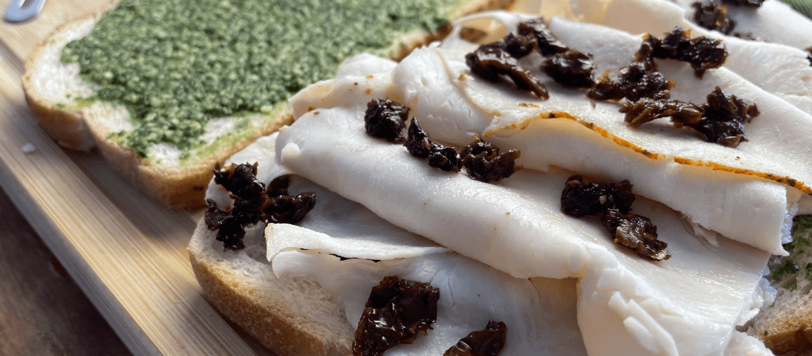 close up of pesto turkey sandwich
